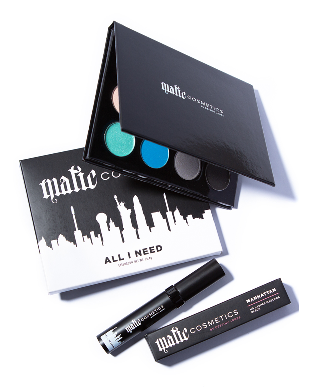 A collection of eyeshadow and mascara from Matic Cosmetics, including a palette with various colors and a black tube of mascara.