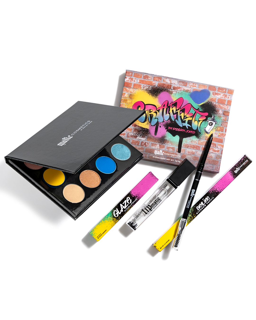 A collection of cosmetics from Matic Cosmetics, including a eyeshadow palette, eyebrow pencil, and lip shine, with packaging that has a colorful, graffiti-inspired design.