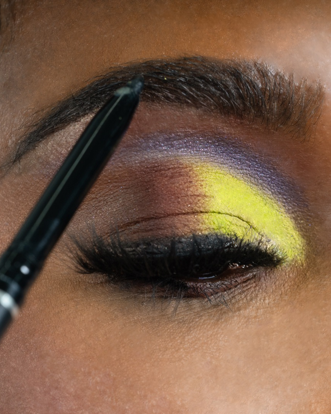 Close up shot of Skyline in soft black being applied to an eyebrow.